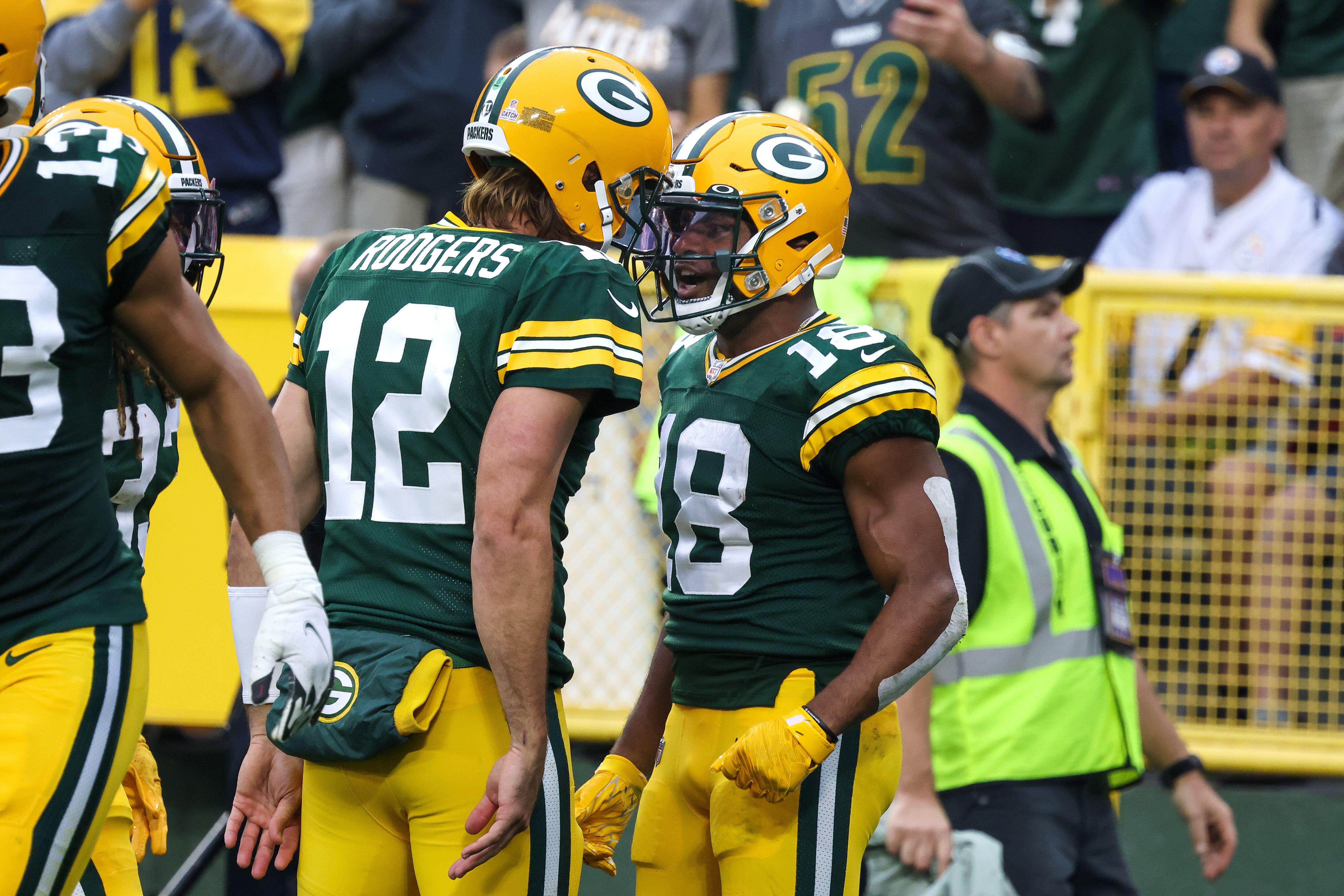 Aaron Rodgers and Randall Cobb celebrating during a game with the Green Bay Packers
