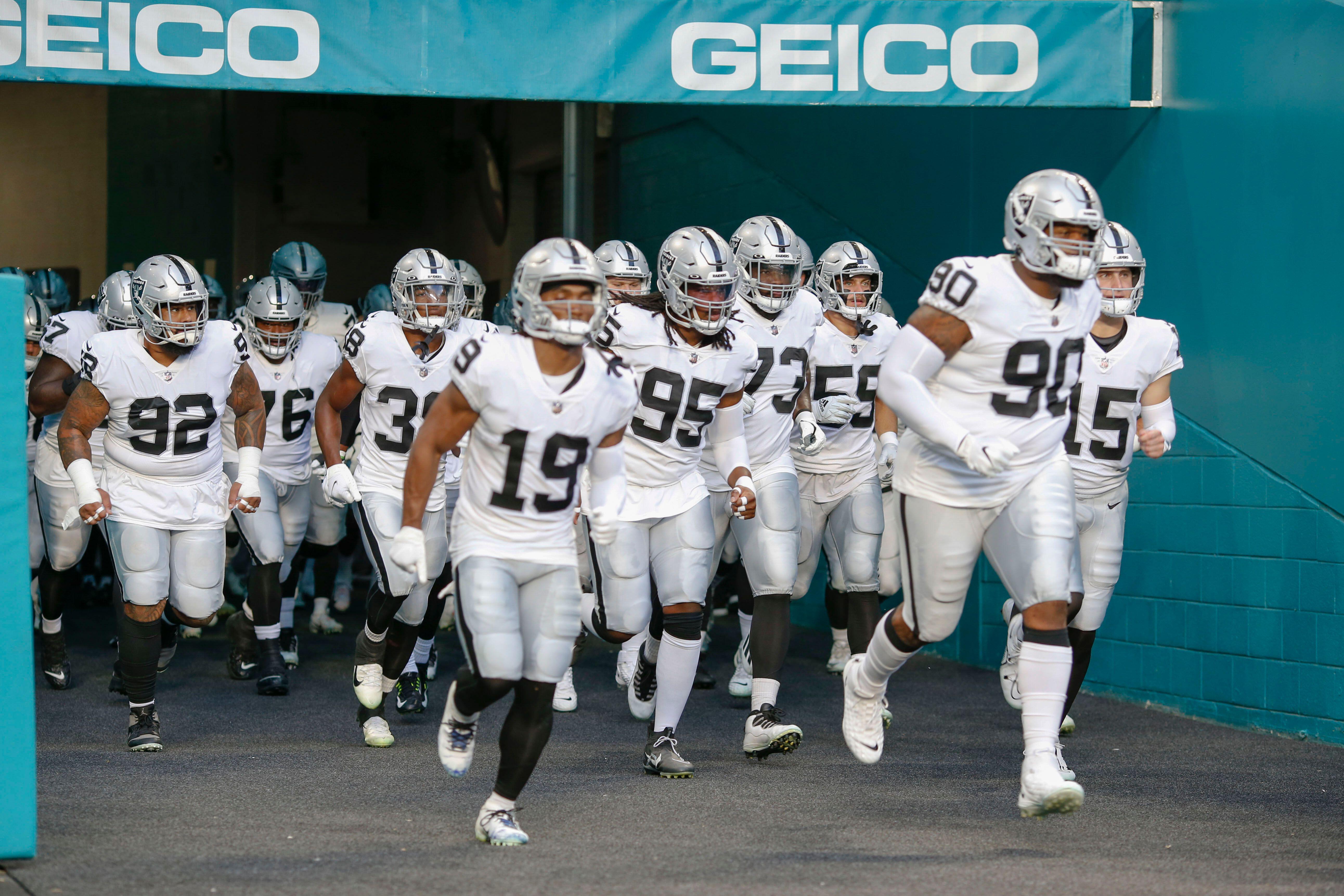 Las Vegas Raiders take the field during an NFL preseason game against the Miami Dolphins